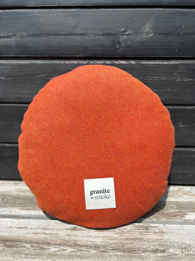 Salvage orange round cushion
